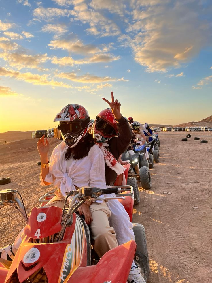 Friends on quads at sunset in the Marrakech desert